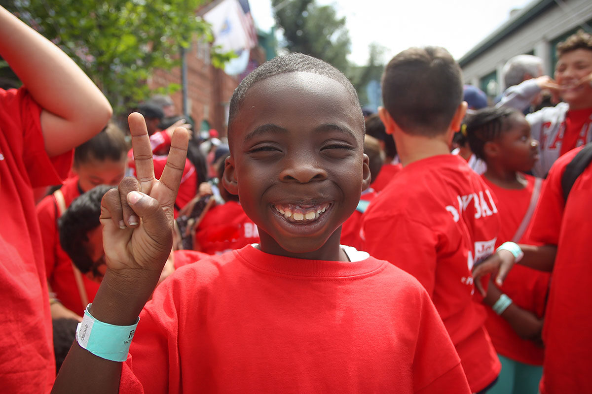 young boy giving the peace sign